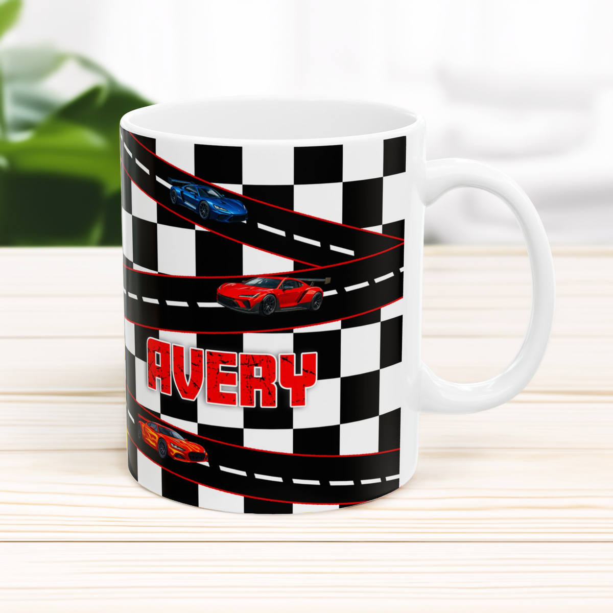 Mug with checkered pattern, race cars, and 'Avery' text on a light wooden surface.