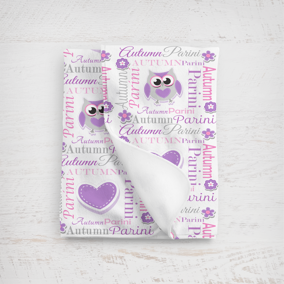 Baby blanket with purple owl design and name text on a white background