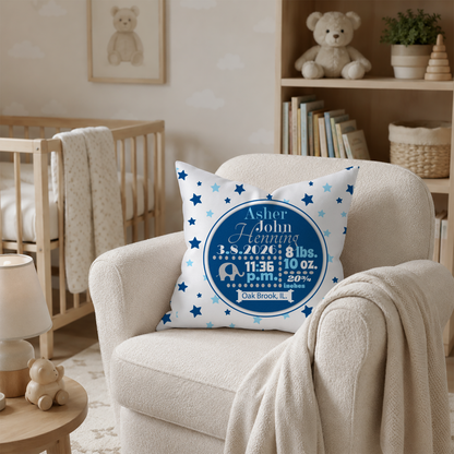 Personalized pillow with baby details on a chair in a nursery