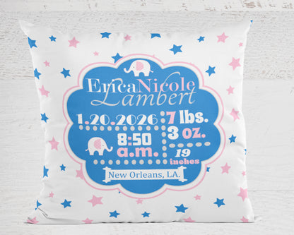Decorative pillow with personalized baby birth details in cerulean blue and pink on a white background