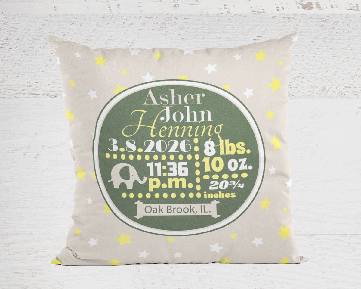 Personalized pillow in tan with baby's birth details on a light wooden background