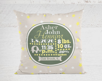 Personalized pillow in tan with baby's birth details on a light wooden background