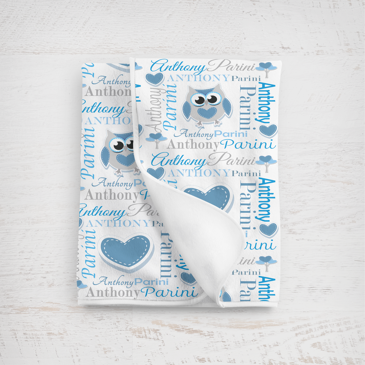 Baby blanket with owl design and personalized text on a white background