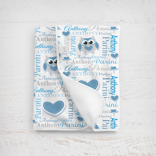 Baby blanket with owl design and personalized text on a white background