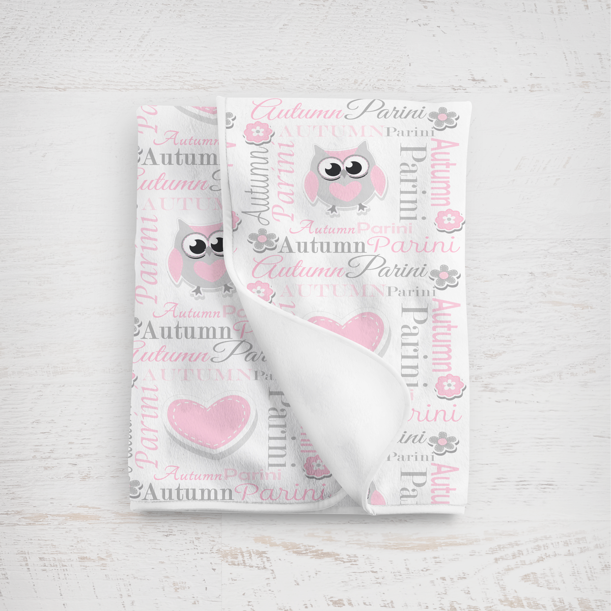Baby blanket in pink and gray lettering with owl design on a white background